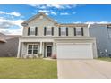 Charming two-story home with a welcoming front yard and a two-car garage, enhanced by black shutters and updated siding at 231 Hayworth Rd, Summerville, SC 29486