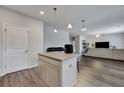 Open living room featuring island with granite countertops, stainless steel appliances, and hardwood floors at 231 Hayworth Rd, Summerville, SC 29486