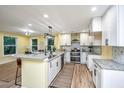 Bright kitchen with white cabinets, stainless appliances, granite countertops, and island at 2647 Tillman St, North Charleston, SC 29405