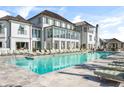 Luxury resort-style pool with ample lounge seating, umbrellas and manicured grounds on a sunny day at 3019 Eventide Dr, Johns Island, SC 29455