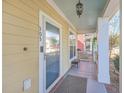 Inviting front porch with a modern door, stylish lighting, and a cozy seating area at 303 Crossandra Ave, Summerville, SC 29483