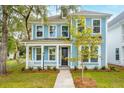 Charming light blue home with a welcoming front porch and manicured lawn at 3148 Vanessa Lynne Ln, Johns Island, SC 29455
