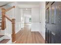 Elegant entryway featuring wood flooring, white trim, and a staircase with wood and white accents at 359 Blue Oak Dr, Moncks Corner, SC 29461