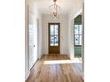 Bright foyer featuring hardwood floors, white trim, and a modern light fixture at 3845 Delinger Dr, Mount Pleasant, SC 29466