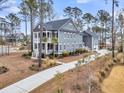 Spacious two-story home with a long driveway, attached garage, and manicured lawn, offering ample space at 3851 Sawyers Island Dr, Mount Pleasant, SC 29466