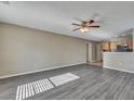 An open-concept living room with wood floors, and seamlessly connected to the kitchen at 512 Resinwood Rd, Moncks Corner, SC 29461