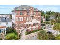 Stately brick building exterior featuring multiple balconies, arched windows, and manicured landscaping at 55 Ashley Ave # 19, Charleston, SC 29401