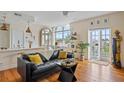 Inviting living room featuring hardwood floors, a stylish couch, and ample natural light from large windows at 55 Ashley Ave # 19, Charleston, SC 29401