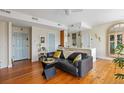 Cozy living area featuring hardwood floors, a modern couch, and an open floor plan to the kitchen at 55 Ashley Ave # 19, Charleston, SC 29401