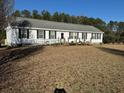 Charming single-story home featuring black shutters and a welcoming front porch with a ramp at 60 Caboose Ct, Cottageville, SC 29435