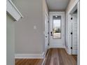 Bright foyer boasts wood-look flooring, modern doors and hardware, and an entry door with glass insert at 6273 Ballpark Rd Rd, Hollywood, SC 29449