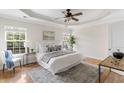 Cozy main bedroom features a tray ceiling, a neutral color palette, and ample natural light at 644 Stoneboro Ct, Charleston, SC 29412