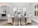 Dining area with hardwood floors, a light chandelier, and large windows that flood the room with natural light at 796 Clay Field Trl, Summerville, SC 29485