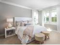 Bright main bedroom features a large bed with elegant linens and decorative pillows, complemented by a light color palette at 798 Clay Field Trl, Summerville, SC 29485