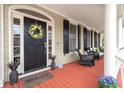 Welcoming front porch with comfortable seating, stylish decor, and a charming entrance, perfect for relaxing outdoors at 8661 Refuge Point Cir, North Charleston, SC 29420
