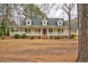 Charming home featuring a welcoming front porch, dormer windows, and well-maintained landscaping at 9030 Ethel Rd, North Charleston, SC 29406