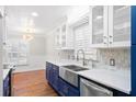 Bright kitchen with stainless steel appliances, quartz countertops, and farm sink with view to dining area at 104 Broadmarsh Ct, North Charleston, SC 29418