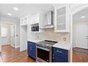 Modern kitchen features stainless steel appliances, including range hood and oven, plus custom cabinets at 104 Broadmarsh Ct, North Charleston, SC 29418