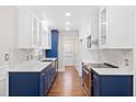 Spacious kitchen featuring custom blue and white cabinets, quartz countertops and stainless steel appliances at 104 Broadmarsh Ct, North Charleston, SC 29418