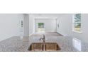 Spacious living area with sleek floors and open concept design flowing into the kitchen and dining space at 1044 Forrest Creek Dr, Summerville, SC 29483