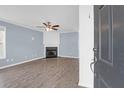 Bright living room with laminate floors, a fireplace, and light blue walls at 105 Thousand Oaks Cir, Goose Creek, SC 29445