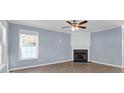 Cozy living room featuring a fireplace, ceiling fan, and soft blue walls at 105 Thousand Oaks Cir, Goose Creek, SC 29445