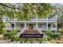 Grand home exterior boasting multi-level balconies, white columns, and meticulous landscaping, offering classic charm and curb appeal at 1126 Ocean Forest Lane, 1/8 Share, Seabrook Island, SC 29455