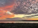 Beach view at dusk with red, orange and grey clouds at 1340 Pelican Watch Villas, Seabrook Island, SC 29455