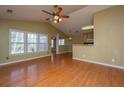 Open-concept living space with hardwood floors and abundant natural light from large windows at 140 Moon Shadow Ln, Summerville, SC 29485