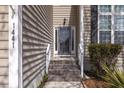 Inviting front entrance with wood-look steps and a glass-paneled door at 1441 Thayer Pl, Mount Pleasant, SC 29466