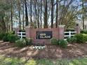 Community sign for Ibis Glade with brick surround, lush landscaping, and neighborhood branding at 1473 Coopers Hawk Dr, Hanahan, SC 29410