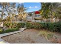 Attractive condo building with well-maintained landscaping and a wooden walkway leading to the entrance at 1614 Live Oak Park, Seabrook Island, SC 29455