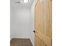 This hallway features modern flooring and a beautiful wooden door at 2124 Booker St, Charleston, SC 29405