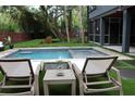 Relaxing pool area with lounge chairs, creating a perfect outdoor retreat for relaxation and enjoyment at 219 Forest Trl, Isle of Palms, SC 29451
