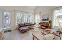 Spacious living room featuring a comfortable leather sectional, classic piano, and abundant natural light at 2317 Chisol Plow St, Mount Pleasant, SC 29466