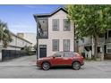 Charming two-story home featuring black trim and a well-maintained yard and a brick driveway and red Toyota at 263 St Philip St, Charleston, SC 29403