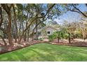 View of a lovely home surrounded by mature trees and a beautifully maintained lawn at 2837 Baywood Dr, Seabrook Island, SC 29455