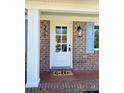 Close-up of front door entrance to brick home with classic accents and stylish lighting at 377 Furman Ln, Ladson, SC 29456