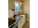 Bright kitchen featuring butcher block countertops, a farmhouse sink, and modern fixtures at 377 Furman Ln, Ladson, SC 29456