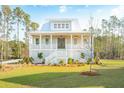 Beautiful two-story home with a covered porch, a well-manicured lawn and a charming craftsman style at 3866 Delinger Dr, Mount Pleasant, SC 29466