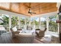 Cozy screened-in porch featuring ceiling fan, fireplace, and marsh views at 4 Falcon Point Rd, Kiawah Island, SC 29455