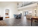 Open concept living space with high ceilings, tile flooring, and seamless flow to the kitchen and dining area at 404 Terrier Rd, Goose Creek, SC 29445