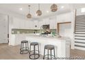 Bright kitchen with white cabinets, stylish pendant lighting, and stainless steel appliances at 409 Avocet Dr # 553P, Summerville, SC 29486