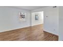 Cozy living room with wood-look floors, natural light from a window, and freshly painted white walls at 415 Parkdale Dr # 12 A, Charleston, SC 29414