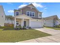 Charming two-story home with front porch, attached two-car garage, and fresh landscaping at 4497 Ocean Farm Dr, Summerville, SC 29485