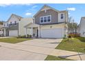 Charming two-story home featuring a two-car garage and manicured front lawn at 4497 Ocean Farm Dr, Summerville, SC 29485