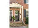 Inviting front entrance with a wreath, stylish lighting, and well-maintained brick facade at 51 Gadsden St # B, Charleston, SC 29401
