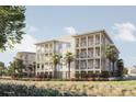 Condos with covered balconies and palm trees sit on manicured grassy lawn at 540 Helmsman St # 1235, Daniel Island, SC 29492