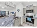 Modern kitchen featuring an island with granite countertops, stainless steel appliances, and an open floor plan at 60 Fenwick Hall Allee # 314, Johns Island, SC 29455