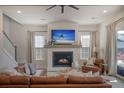 Cozy living room with a fireplace, large leather sectional, and ample natural light at 643 Blueway Ave, Summerville, SC 29486